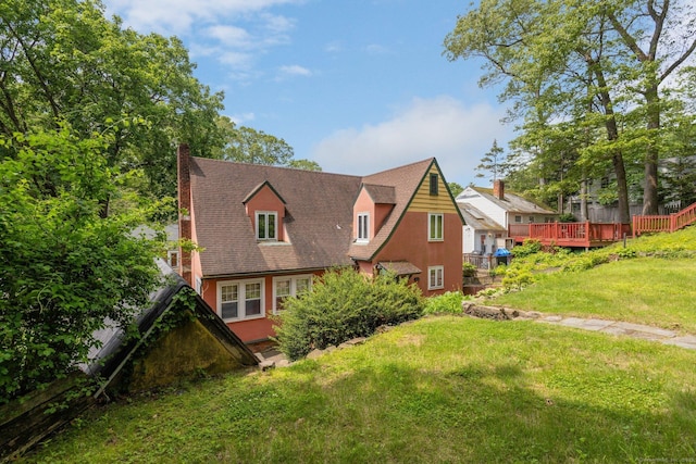 73 Hemlock Rd, New Haven, CT 06515 - back of property featuring a chimney, a yard, and a deck