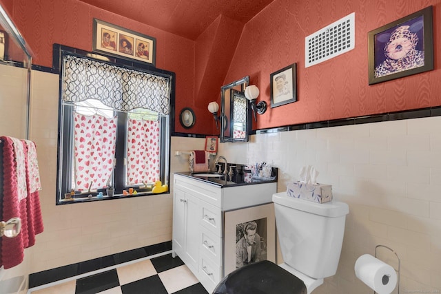 73 Hemlock Rd, New Haven, CT 06515 - full bathroom with vanity, wainscoting, tile walls, and tile patterned floors