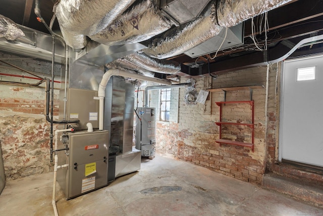 73 Hemlock Rd, New Haven, CT 06515 - basement with gas water heater, healthy amount of natural light, heating unit, and brick wall