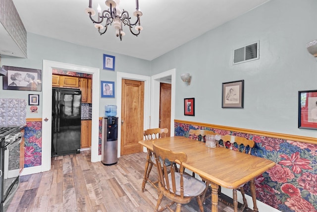 73 Hemlock Rd, New Haven, CT 06515 - dining space featuring a chandelier, light wood-type flooring, and wainscoting