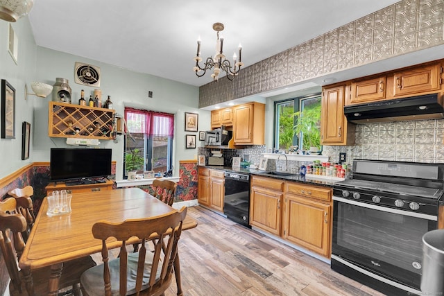 73 Hemlock Rd, New Haven, CT 06515 - kitchen featuring range with gas stovetop, black dishwasher, under cabinet range hood, light wood-style flooring, and a chandelier