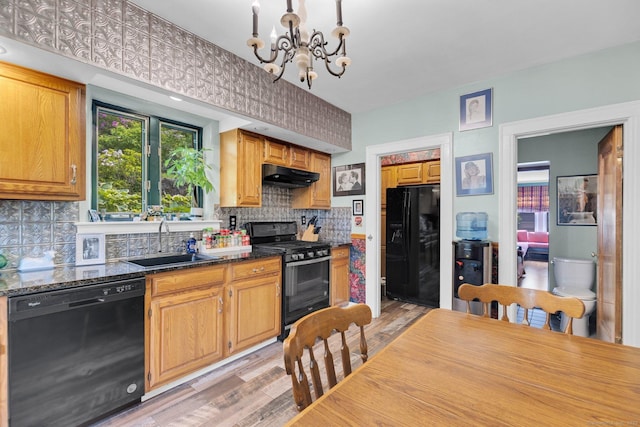 73 Hemlock Rd, New Haven, CT 06515 - kitchen with black appliances, under cabinet range hood, a chandelier, light wood-style floors, and tasteful backsplash