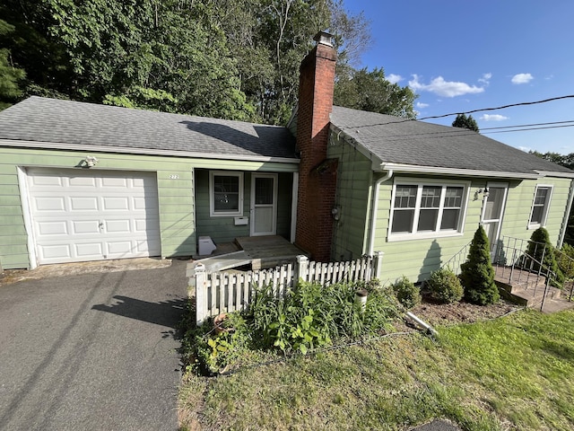 272 Bell St, Glastonbury, CT 06033 - view of front of property featuring an attached garage, a chimney, asphalt driveway, and a shingled roof