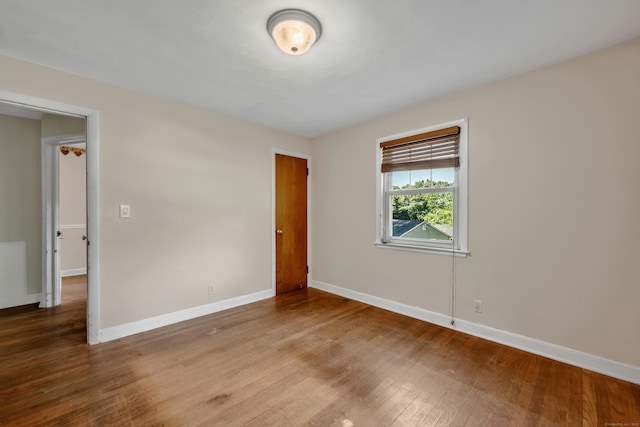 272 Bell St, Glastonbury, CT 06033 - unfurnished bedroom featuring wood finished floors, baseboards, and a closet
