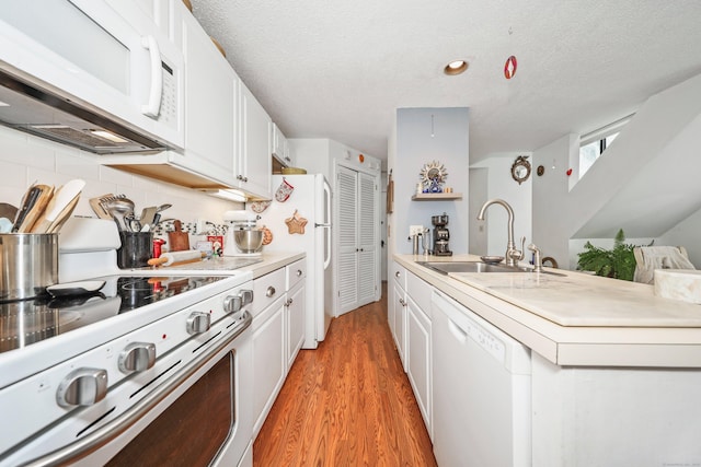 26 Evergreen Rd Unit 26, Torrington, CT 06790 - kitchen featuring white appliances, a sink, light wood-style floors, light countertops, and tasteful backsplash