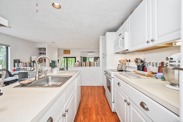 26 Evergreen Rd Unit 26, Torrington, CT 06790 - kitchen with white appliances, a sink, plenty of natural light, light wood finished floors, and a textured ceiling