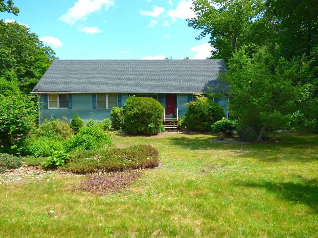 62 Bascom Rd, Lebanon, CT 06249 - view of front of house with a shingled roof and a front lawn