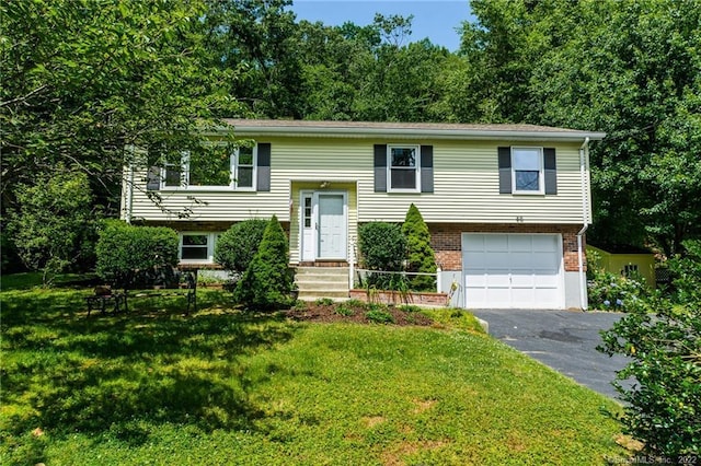 46 Quarry Dock Rd, East Lyme, CT 06357 - split foyer home featuring asphalt driveway, an attached garage, a front yard, and brick siding