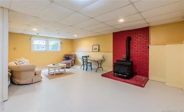 46 Quarry Dock Rd, East Lyme, CT 06357 - living area featuring a wood stove, a drop ceiling, and finished concrete flooring