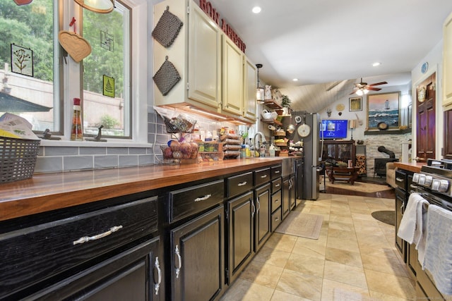 56 Giants Neck Rd, East Lyme, CT 06357 - kitchen featuring wood counters, a ceiling fan, decorative backsplash, gas range, and a sink