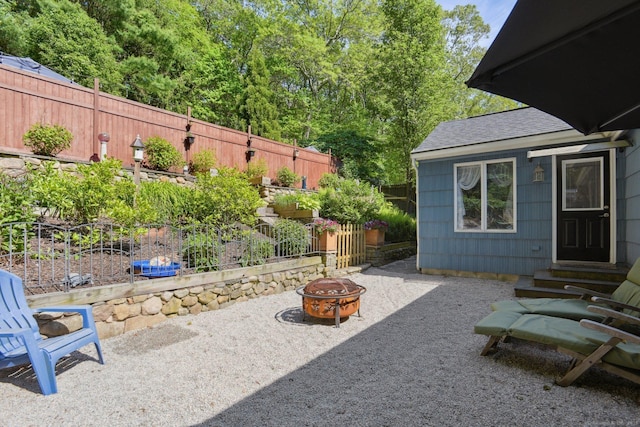 56 Giants Neck Rd, East Lyme, CT 06357 - fenced backyard with a fire pit, entry steps, and a patio