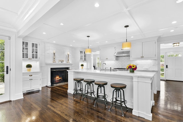 7 Over Rock Ln, Westport, CT 06880 - kitchen with under cabinet range hood, coffered ceiling, dark wood-style floors, white cabinets, and recessed lighting