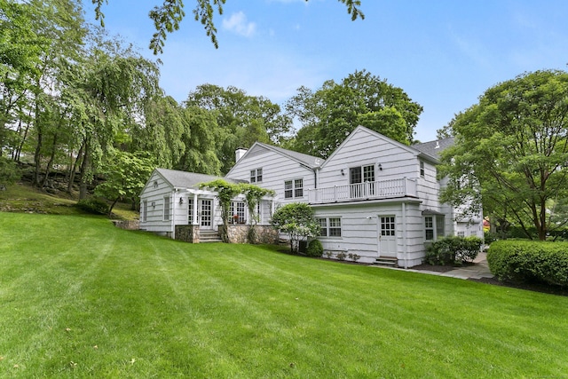7 Over Rock Ln, Westport, CT 06880 - rear view of house with a balcony, entry steps, and a lawn