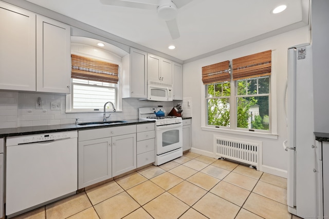 161 Crestwood Rd, Fairfield, CT 06824 - kitchen with radiator, white appliances, a sink, dark countertops, and plenty of natural light