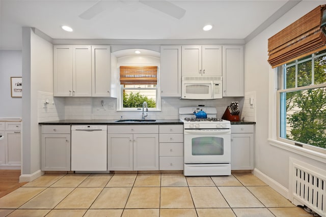 161 Crestwood Rd, Fairfield, CT 06824 - kitchen featuring white appliances, radiator, a sink, dark countertops, and recessed lighting
