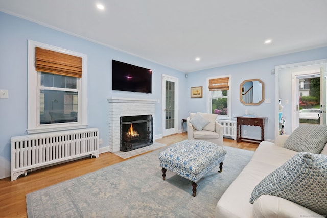 161 Crestwood Rd, Fairfield, CT 06824 - living room with radiator heating unit, wood finished floors, a fireplace, and recessed lighting