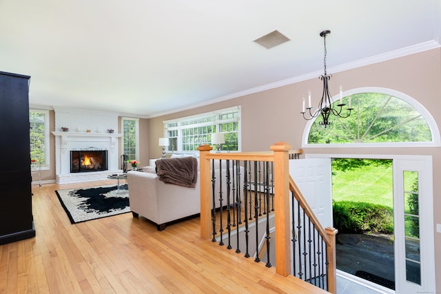 21 Forest Rd, Weston, CT 06883 - living area featuring wood-type flooring, healthy amount of natural light, a chandelier, and ornamental molding