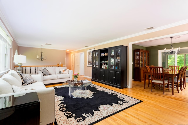 21 Forest Rd, Weston, CT 06883 - living room with a chandelier, ornamental molding, and light wood finished floors