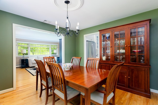 21 Forest Rd, Weston, CT 06883 - dining space featuring a chandelier, light wood finished floors, baseboards, and baseboard heating