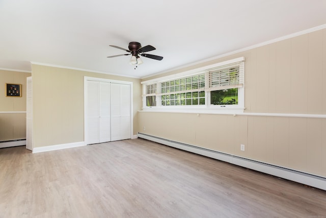 21 Forest Rd, Weston, CT 06883 - unfurnished bedroom with a baseboard heating unit, a closet, wood finished floors, ornamental molding, and baseboards