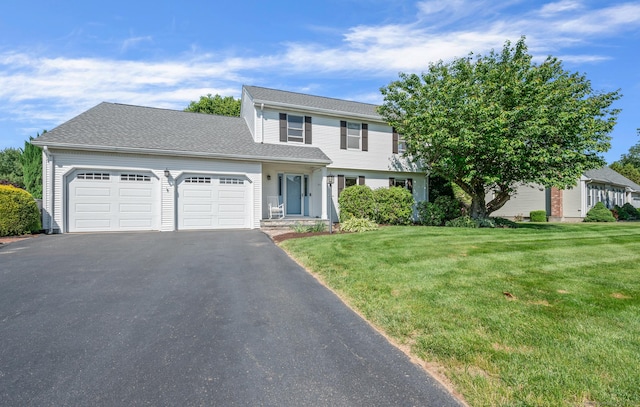 31 S Meadow Ln, Enfield, CT 06082 - view of front facade with a garage, driveway, and a front lawn