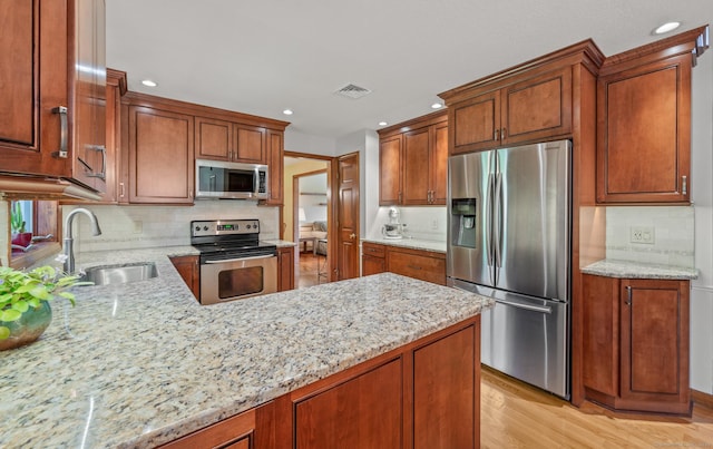 31 S Meadow Ln, Enfield, CT 06082 - kitchen with stainless steel appliances, a sink, recessed lighting, light stone countertops, and tasteful backsplash