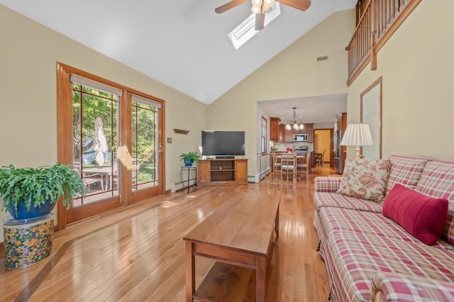 31 S Meadow Ln, Enfield, CT 06082 - living area with a baseboard heating unit, a ceiling fan, light wood-style flooring, high vaulted ceiling, and a chandelier