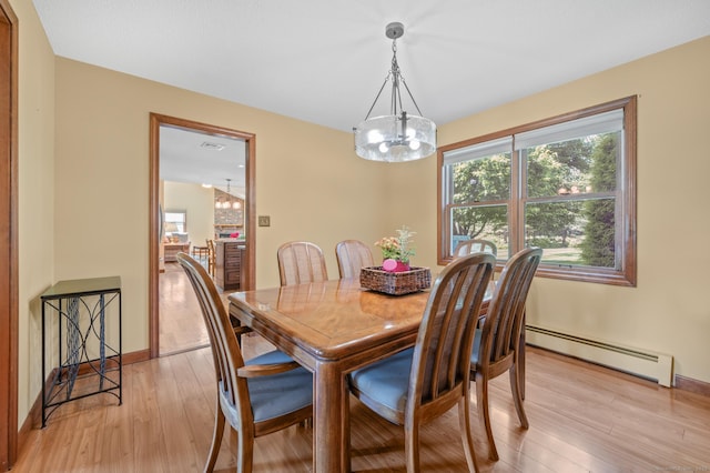 31 S Meadow Ln, Enfield, CT 06082 - dining area with a chandelier, a baseboard radiator, light wood-style floors, and baseboards