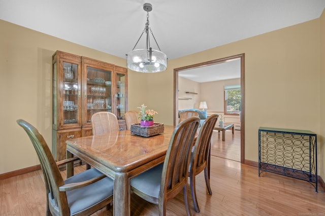 31 S Meadow Ln, Enfield, CT 06082 - dining area with a chandelier, light wood-style flooring, and baseboards