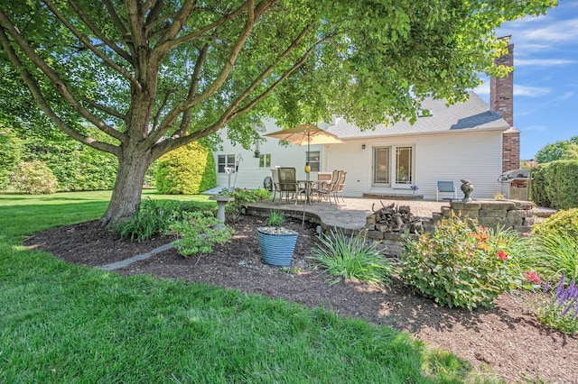 31 S Meadow Ln, Enfield, CT 06082 - back of property with a yard, a patio area, a chimney, and roof with shingles