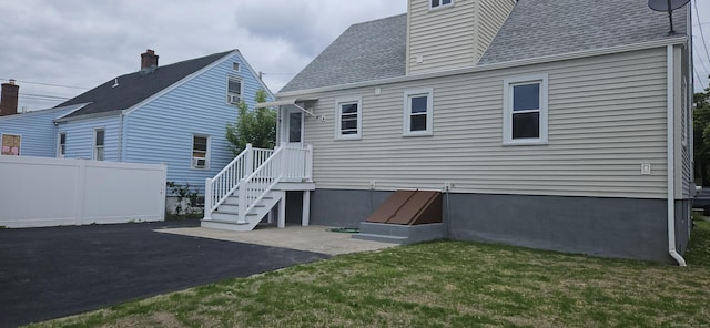 265 Harlem Ave, Bridgeport, CT 06606 - rear view of house featuring roof with shingles and a patio