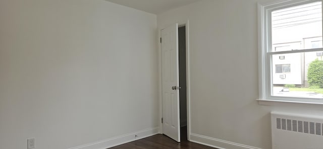 265 Harlem Ave, Bridgeport, CT 06606 - empty room with radiator heating unit, dark wood-type flooring, and baseboards