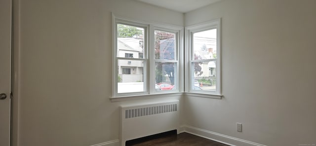 265 Harlem Ave, Bridgeport, CT 06606 - empty room with radiator, dark wood-style floors, and baseboards