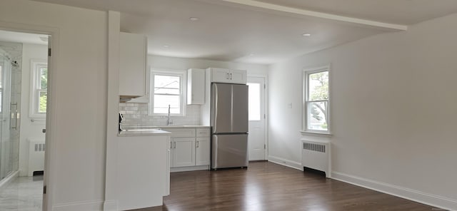 265 Harlem Ave, Bridgeport, CT 06606 - kitchen featuring freestanding refrigerator, radiator heating unit, decorative backsplash, baseboards, and light countertops
