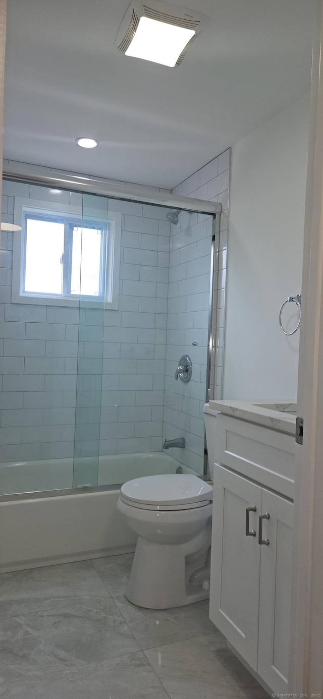 265 Harlem Ave, Bridgeport, CT 06606 - bathroom featuring marble finish flooring, vanity, bath / shower combo with glass door, and toilet
