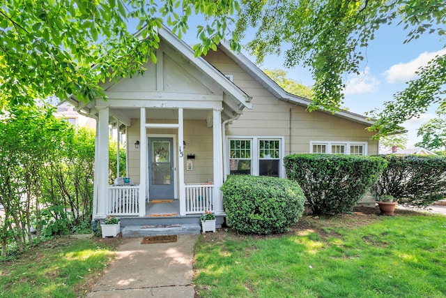 15 Dartley St, Stamford, CT 06905 - view of front of home featuring covered porch and a front yard