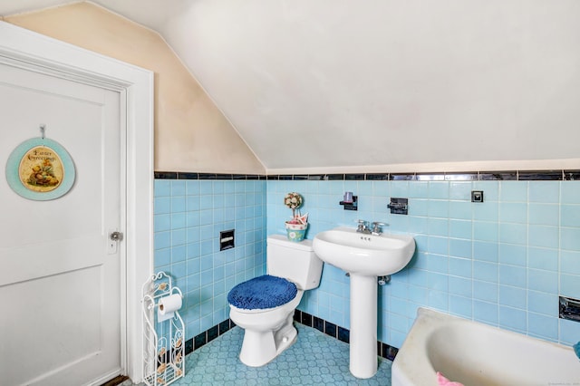 15 Dartley St, Stamford, CT 06905 - full bathroom with toilet, lofted ceiling, tile walls, wainscoting, and a bathtub