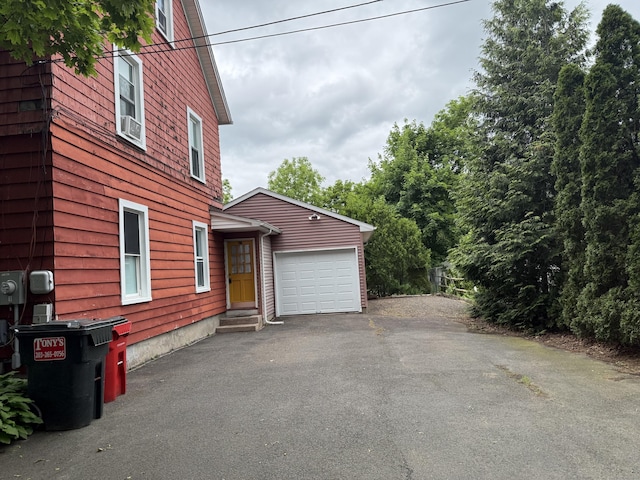 39 Swain Ave, Meriden, CT 06450 - view of side of home with an attached garage and asphalt driveway