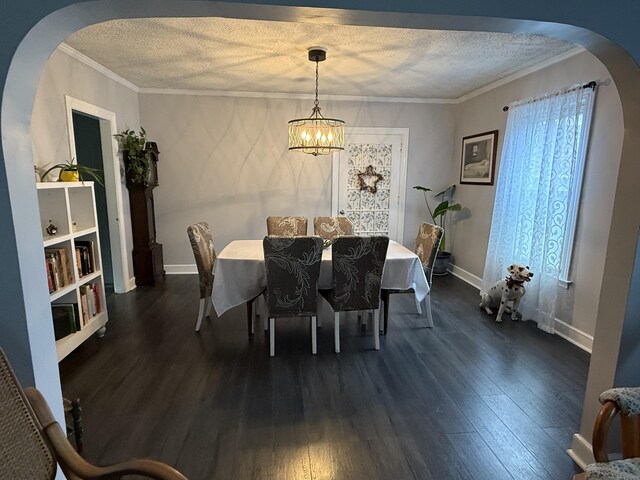 39 Swain Ave, Meriden, CT 06450 - dining area featuring arched walkways, a chandelier, dark wood-style floors, crown molding, and a textured ceiling