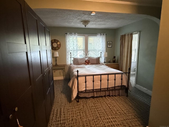 39 Swain Ave, Meriden, CT 06450 - carpeted bedroom with a textured ceiling, baseboards, and arched walkways