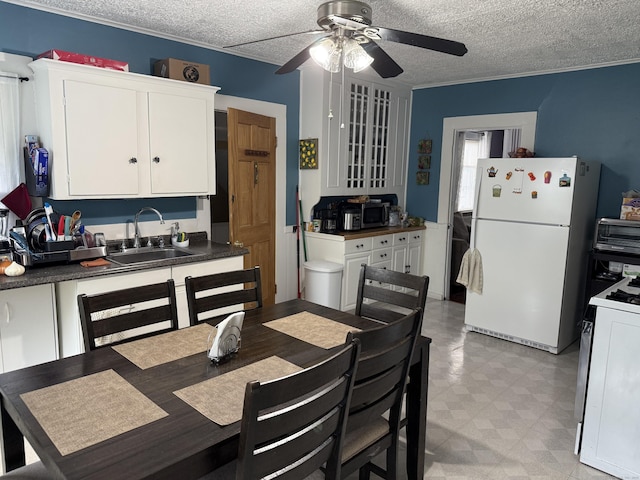 39 Swain Ave, Meriden, CT 06450 - dining room featuring a ceiling fan, a textured ceiling, and light flooring