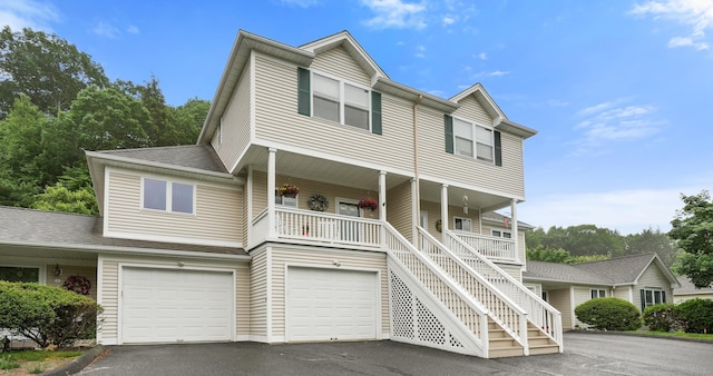 2 Turtle Spring Ln Unit 2, Newtown, CT 06470 - view of front facade featuring asphalt driveway, a porch, an attached garage, stairs, and a shingled roof