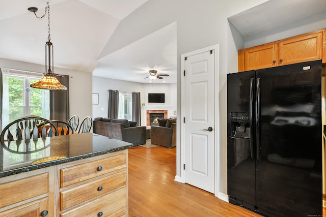 2 Turtle Spring Ln Unit 2, Newtown, CT 06470 - kitchen with black fridge with ice dispenser, a ceiling fan, vaulted ceiling, light wood-type flooring, and a fireplace