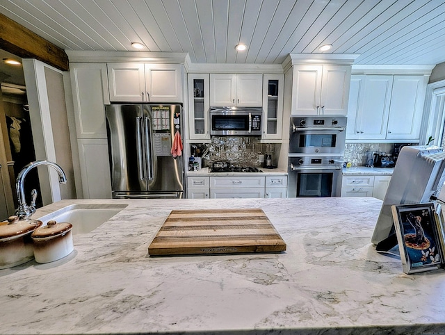 1036 Heritage Vlg Unit A, Southbury, CT 06488 - kitchen with appliances with stainless steel finishes, a sink, wood ceiling, tasteful backsplash, and white cabinetry