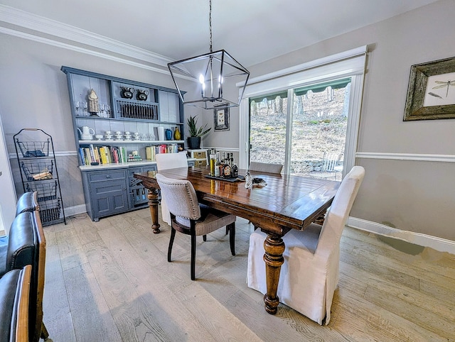 1036 Heritage Vlg Unit A, Southbury, CT 06488 - dining space featuring light wood finished floors, a chandelier, baseboards, and ornamental molding