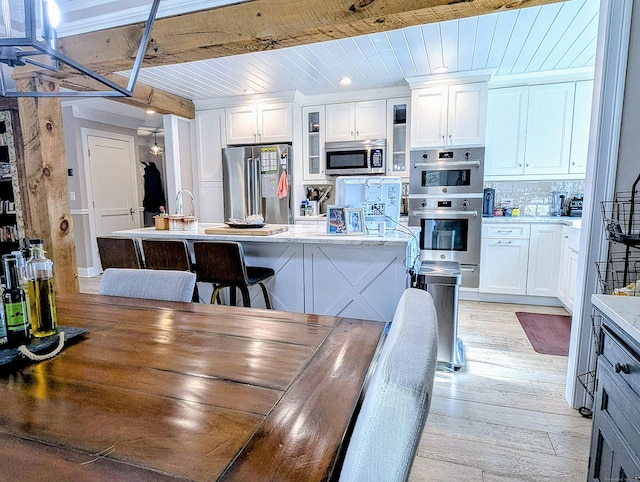 1036 Heritage Vlg Unit A, Southbury, CT 06488 - dining space featuring light wood-type flooring and wooden ceiling with exposed beams