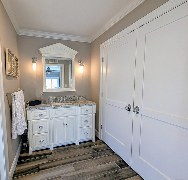 1036 Heritage Vlg Unit A, Southbury, CT 06488 - bathroom featuring ornamental molding, vanity, wood finished floors, and baseboards