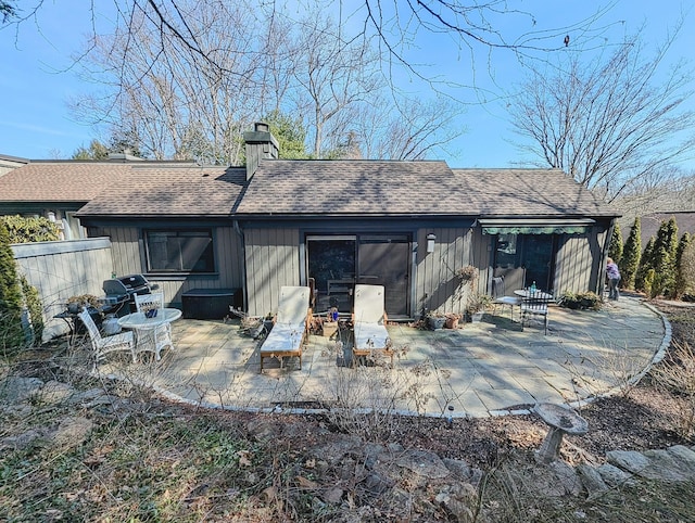 1036 Heritage Vlg Unit A, Southbury, CT 06488 - rear view of property featuring a chimney, a patio, and roof with shingles