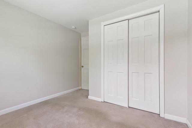 205 Ocean View Ave, Groton, CT 06355 - unfurnished bedroom with light carpet, baseboards, and a closet