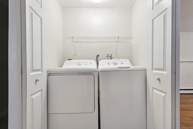 205 Ocean View Ave, Groton, CT 06355 - laundry area featuring washing machine and clothes dryer, a baseboard radiator, and wood finished floors
